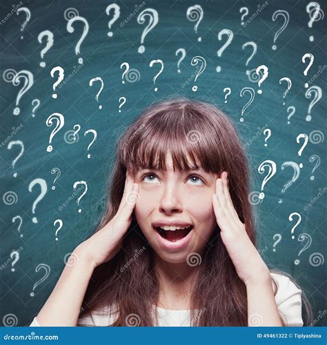 Young Girl With Questioning Expression And Question Marks Stock Photo
