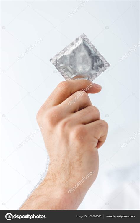 Man Holding Condom Stock Photo Dmitrypoch