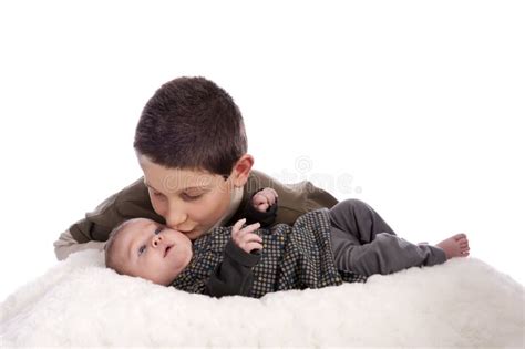 Big Brother Giving A Kiss At This Baby Sister Royalty Free Stock Photo