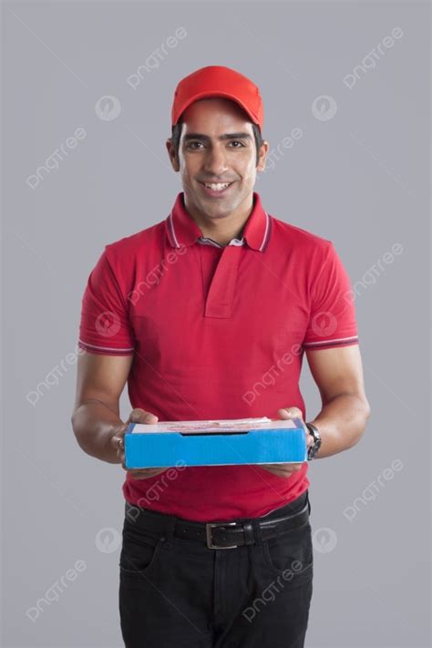 portrait of smiling pizza delivery man against gray background photo and picture for free