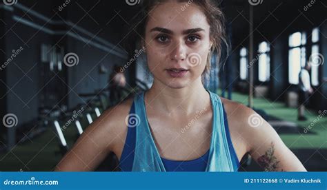 Portrait Of Serious Beautiful Young Determined Female Athlete Looking At Camera Sweaty After