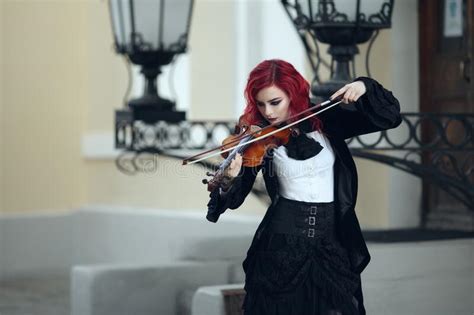 Red Haired Vampire Girl Plays The Violin In An Old Museum In Gothic