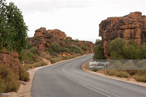 A Tarred Road Winds Past Weathered Rock Formations Through The Pakhuis