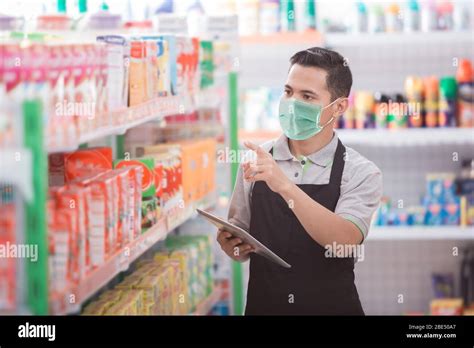 Asian Male Shopkeeper Working In A Grocery Store Stock Photo Alamy