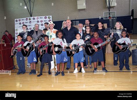 Andre Agassi Joins Carlos Santana For Musical Instrument Donation At