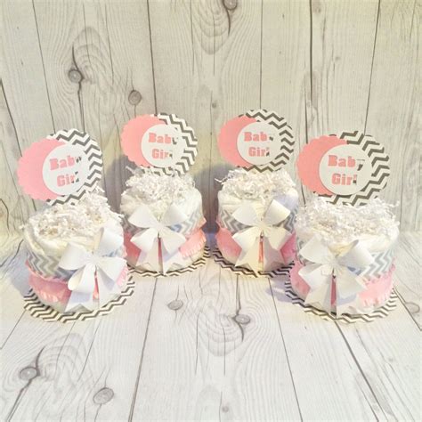 It is approximately 2 weeks worth of diapers for a newborn baby. Mini Diaper Cake Centerpiece kit Baby Pink Gray and White