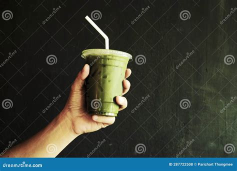 Savoring Serenity - Hand Holding Iced Matcha Latte Green Tea Stock