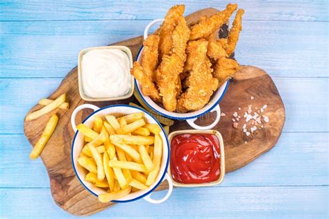 Chicken Breaded Strips In Small Ceramic Pots With Ketchup And White