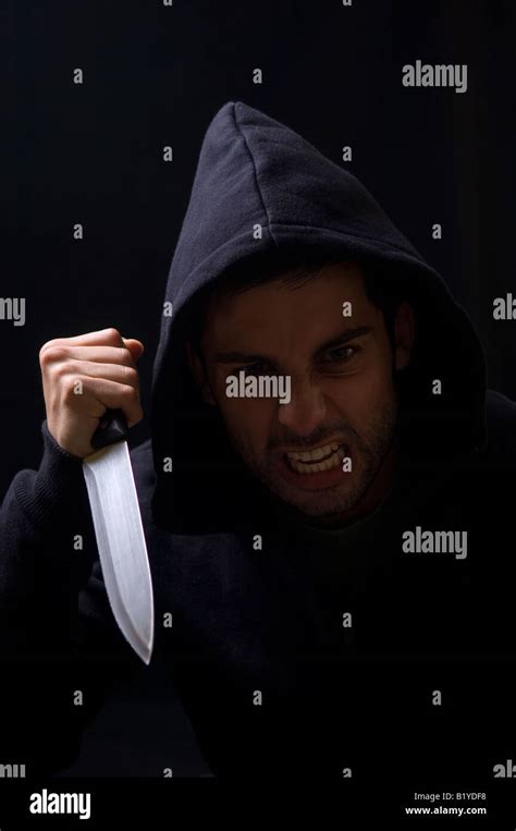 Angry Hooded Man Holding A Knife Stock Photo Alamy