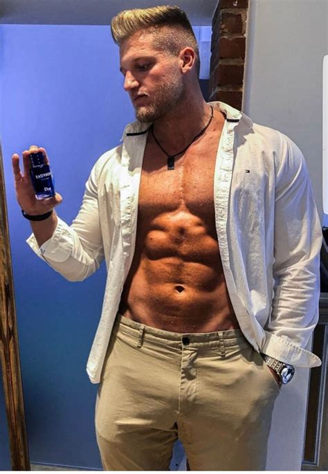 A Shirtless Man Taking A Selfie With His Cell Phone