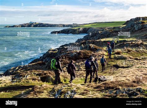 Walkers Walking From Amlwch To Llaneilian Along Anglesey Coastal Path