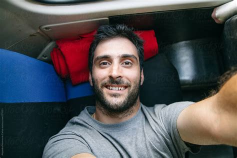 Young Man Selfie Lying Down On The Back Seat Of A Bus While Traveling