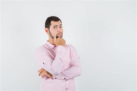Free Photo Young Man Standing While Thinking In Pink Shirt And