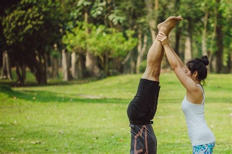 Free Photo Woman Helping Her Partner To Handstand