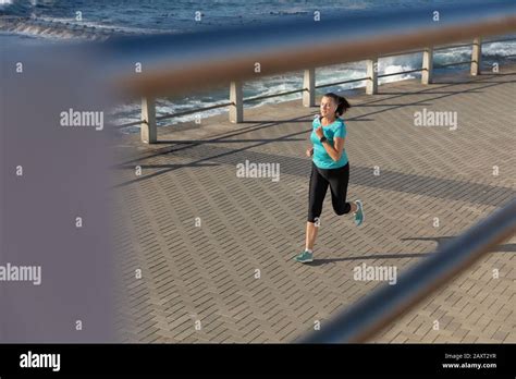 Female Jogger Running On Seaside Stock Photo Alamy