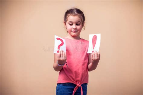 A Portrain Of Kid Boy Holding Cards With Question Mark And Exclamation