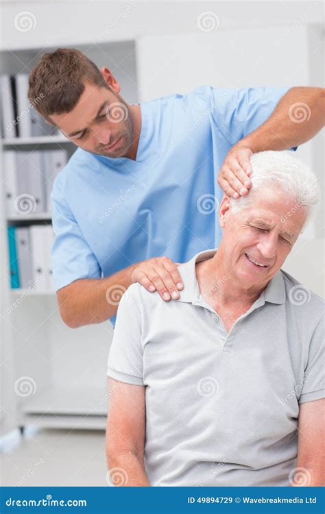 Therapist Giving Massage To Senior Male Patient Stock Image Image Of Physiotherapist Nurse