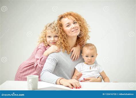 Attractive Ginger Mommy And Her Adorable Fair Haired Children Stock