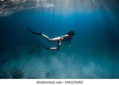 Free Diver Woman Fins Glides Underwater Stock Photo