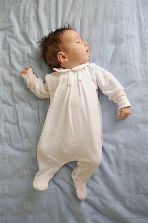 Newborn Baby Girl Sleeping On Blue Sheets Stock Photo 180771