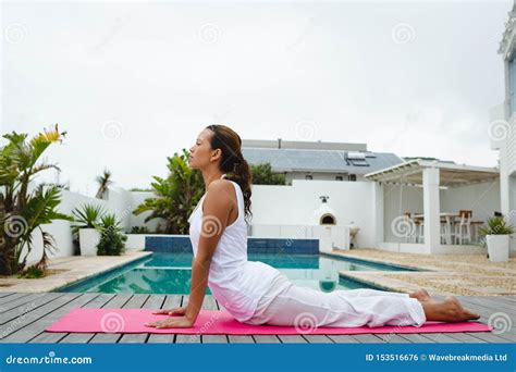 Woman Performing Yoga Near Swimming Pool In The Backyard Stock Photo Image Of Ethnicity