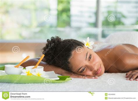 Gorgeous Woman Lying On Massage Table With Salt Treatment On Back Stock