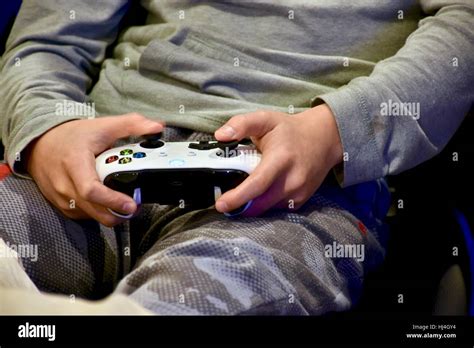 A Young Teen Holding An Xbox One Controller While Playing Xbox Games