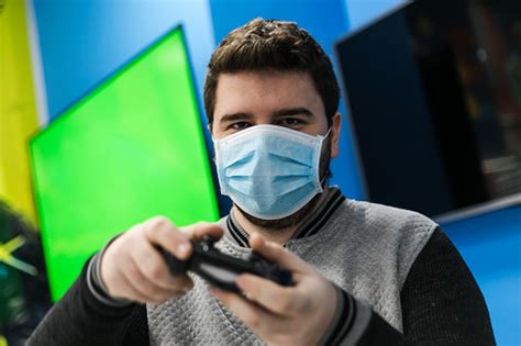 One Guy Playing Video Games On Green Screen Stock Photo Download