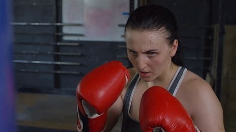 Close Up Slow Motion Shot Of Young Sweaty Woman In Red Boxing Gloves