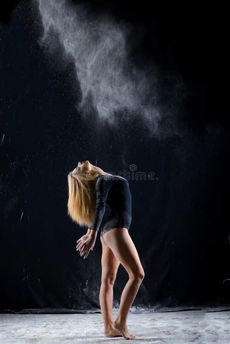 Beautiful Blonde Girl Wearing A Black Gymnastic Bodysuit Covered With