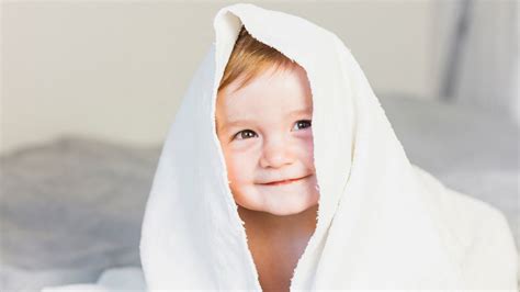 Smiley Face Closeup View Of Cute Baby Wallpaper White Towel Blur