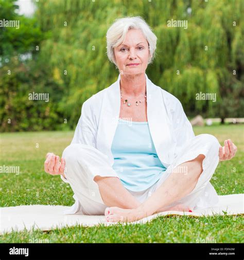 Senior Healthy Old Woman Practicing Yoga And Tai Chi Outdoor Stock