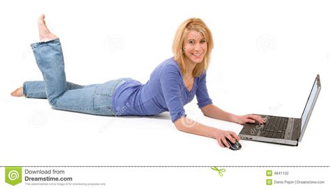 Blonde Woman Lying Down And Using Laptop Stock Photo