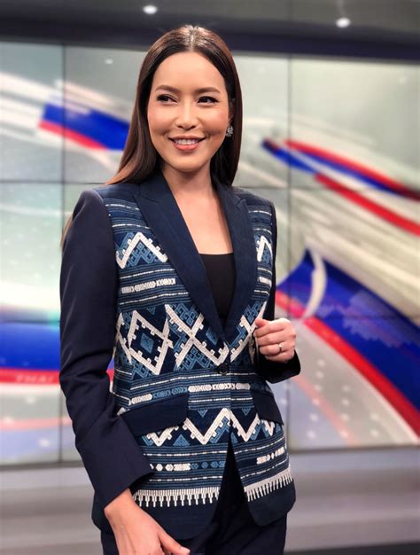 A Woman Is Standing In Front Of A News Set