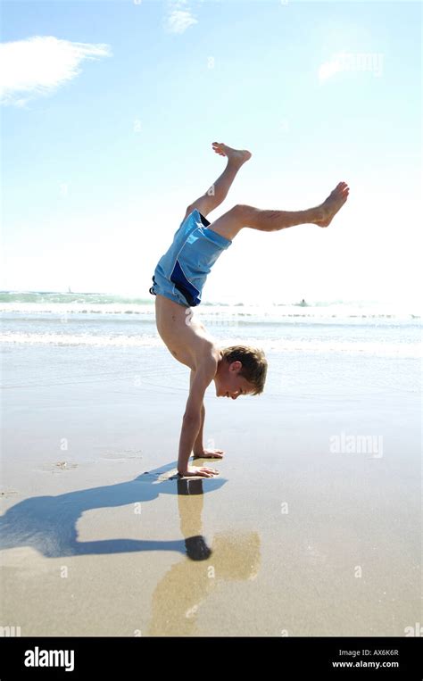 Side Profile Of Boy Doing Handstand On Beach Stock Photo Alamy