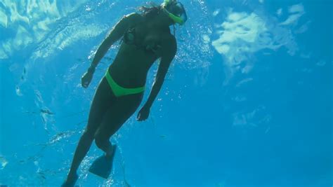 Log in / sign up to vote & review! Underwater Angle Looking Up Of Woman Snorkeling In Blue ...
