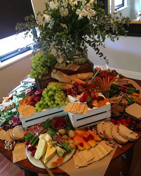 A Table Topped With Lots Of Different Types Of Cheeses And Crackers