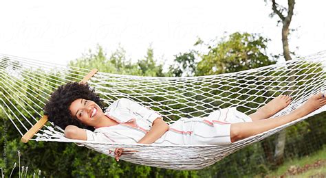 African American Woman Relaxing In Hammock In Backyard By Trinette Reed