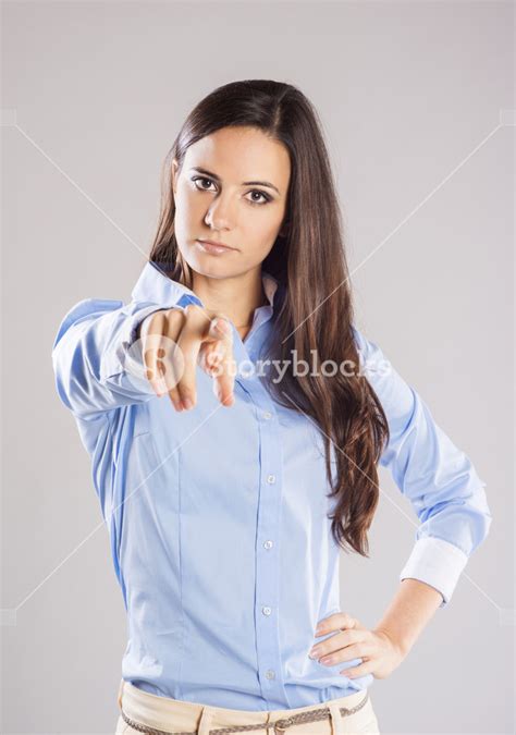 Beautiful Young Woman Pointing To Somewhere Isolated Over A White