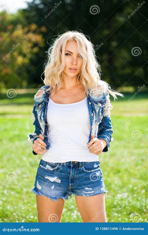 Beautiful Blonde Woman Dressed In A Denim Jacket And Shorts Stock Photo Image Of Female Close