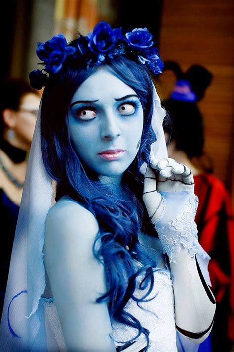 A Woman With Blue Hair And Makeup Is Dressed As Corpse Bride