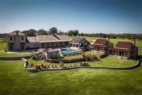 An Aerial View Of A Large House With A Pool In The Middle And Lots Of