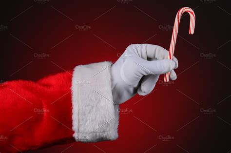 Santa Claus Hand Holding Candy Cane High Quality Holiday Stock Photos