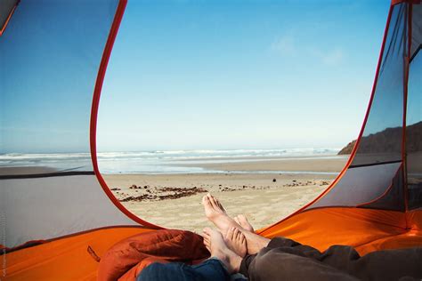 Couples Sandy Feet Sticking Out Of Tent Camping On The Beach Del Colaborador De Stocksy Kate
