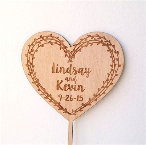 A Heart Shaped Wooden Sign With The Words Lindsay And Kern Engraved On It
