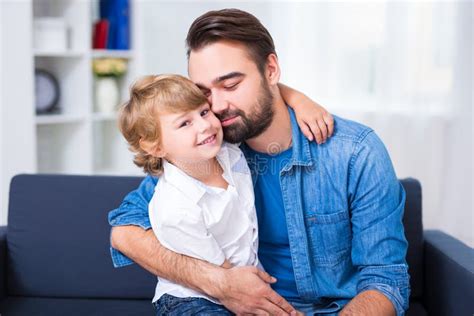 Young Father Embracing His Little Son Stock Image Image Of Indoors