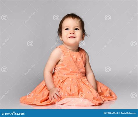 Adorable Girl Sitting In A Beautiful Pink Dress With A Skirt Stock