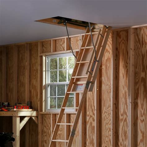werner w 8 75 ft to 10 33 ft rough opening 25 in x 54 in folding wood attic ladder with 250