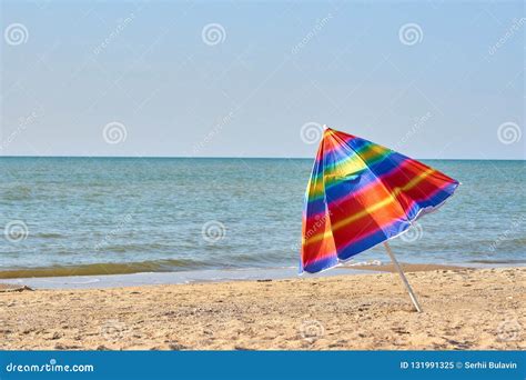 Folded Colored Beach Umbrella On The Beach Closing Of The Holiday