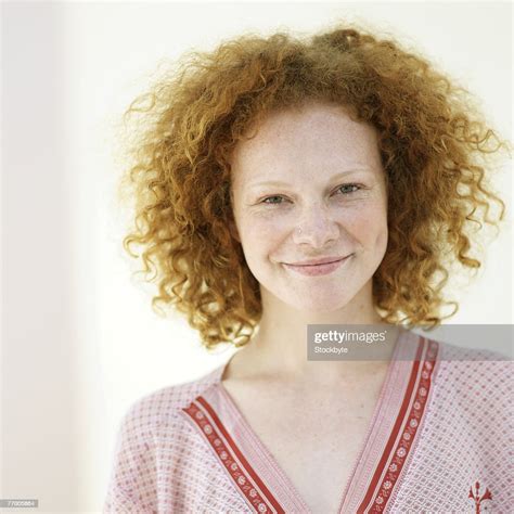 Young Woman With Red Curly Hair Smiling Portrait Head And Shoulders